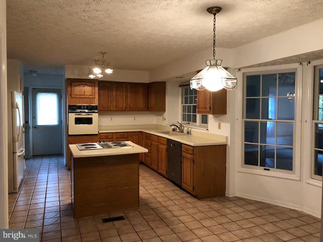 1217 Brookview Road Baltimore, MD 21286 - Photo 7 of 16 a kitchen with a sink stove and cabinets
