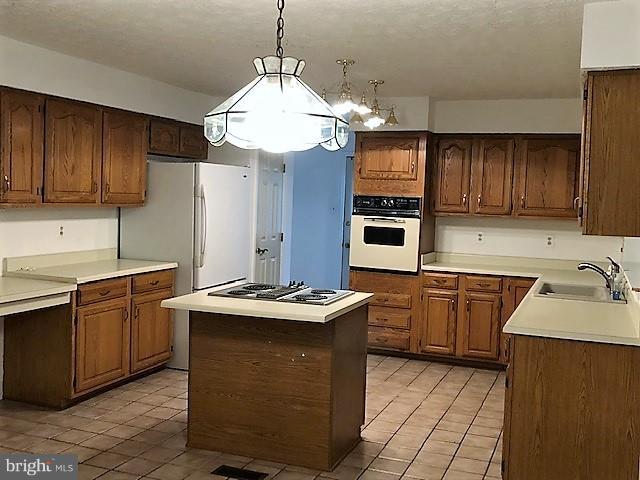 1217 Brookview Road Baltimore, MD 21286 - Photo 8 of 16 a kitchen with stainless steel appliances granite countertop a sink stove and refrigerator