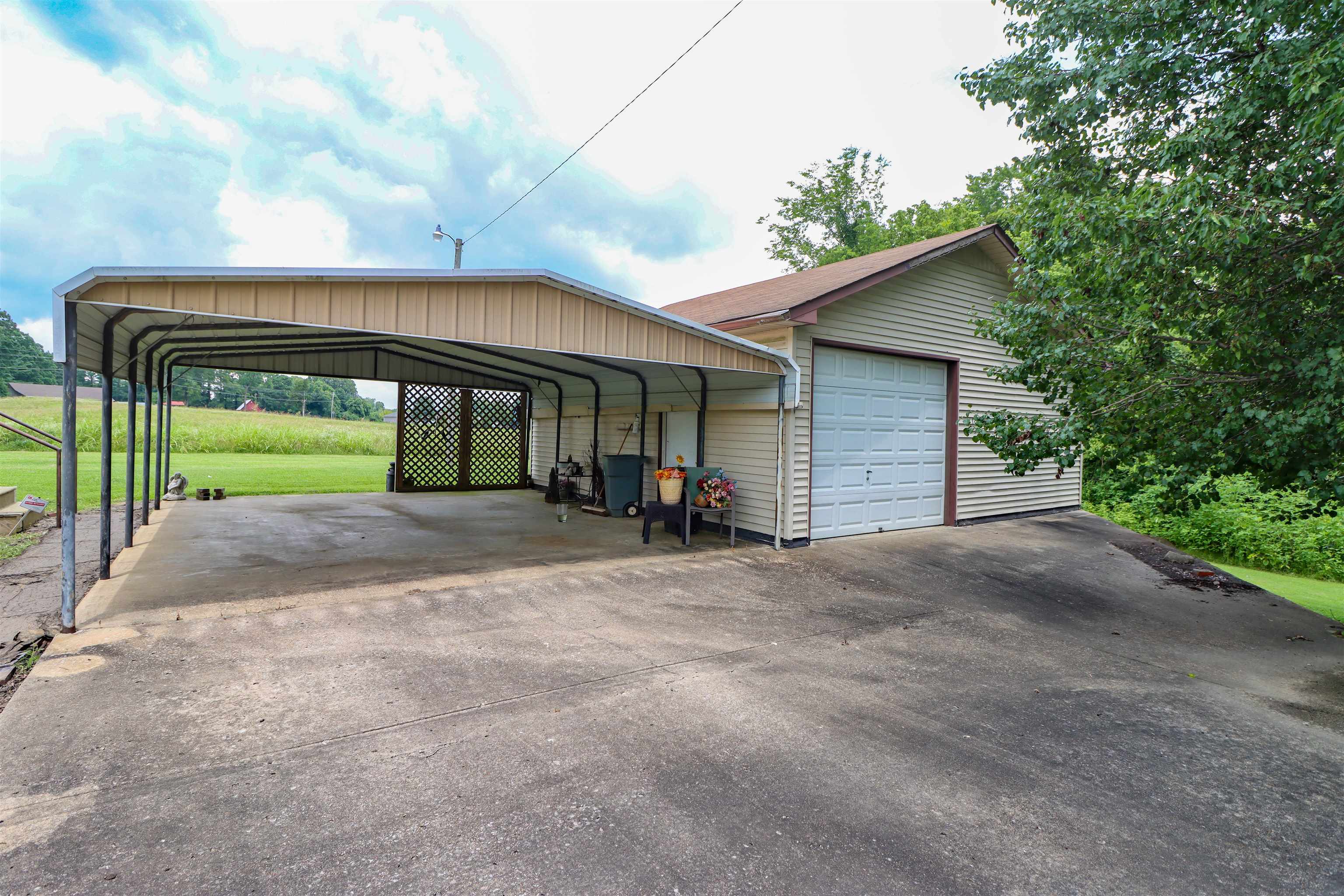 2250 Chisholm Lake Road Ripley, TN 38063 - Photo 23 of 32 a view of a house with a yard and garage