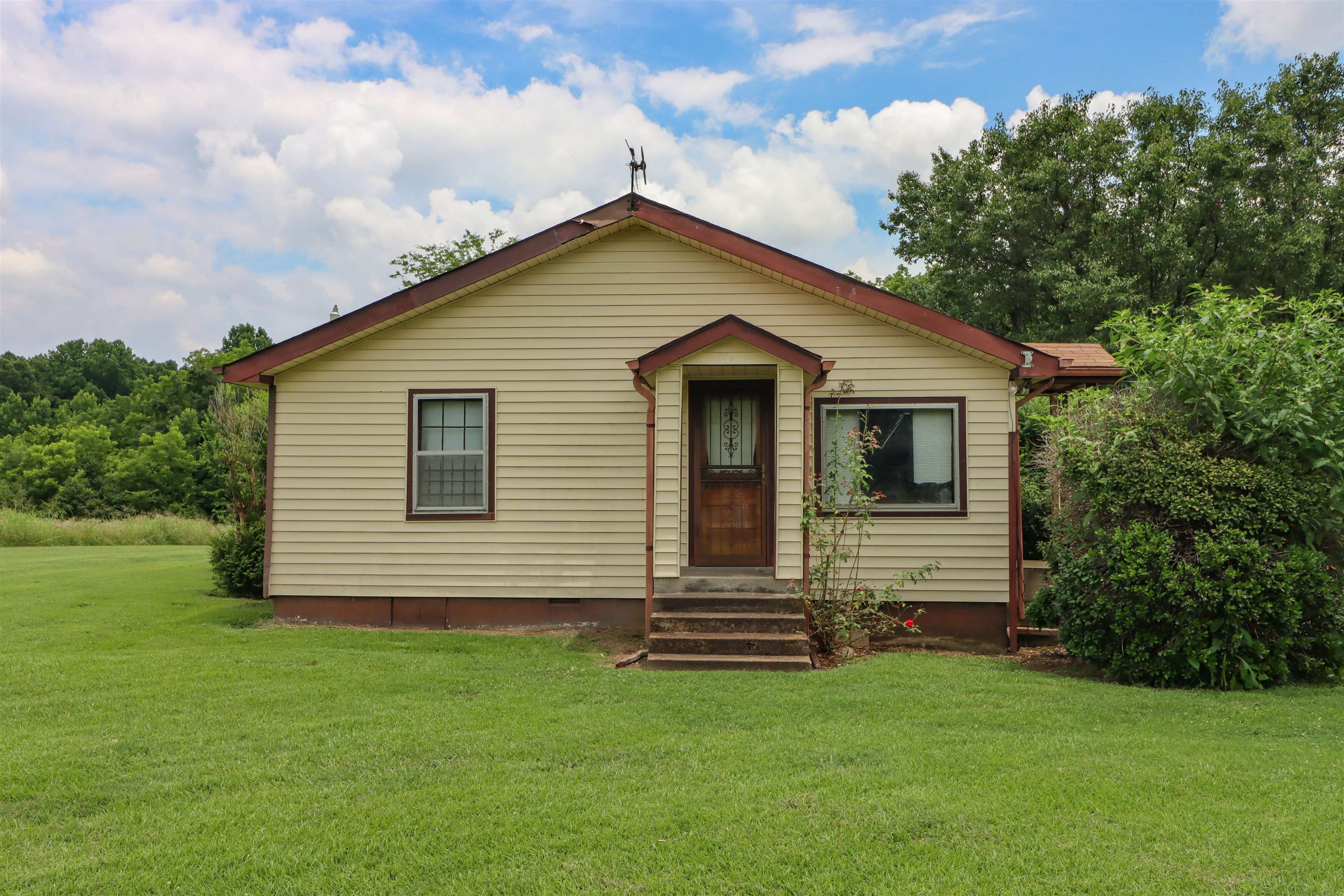 2250 Chisholm Lake Road Ripley, TN 38063 - Photo 26 of 32 a front view of a house with a garden