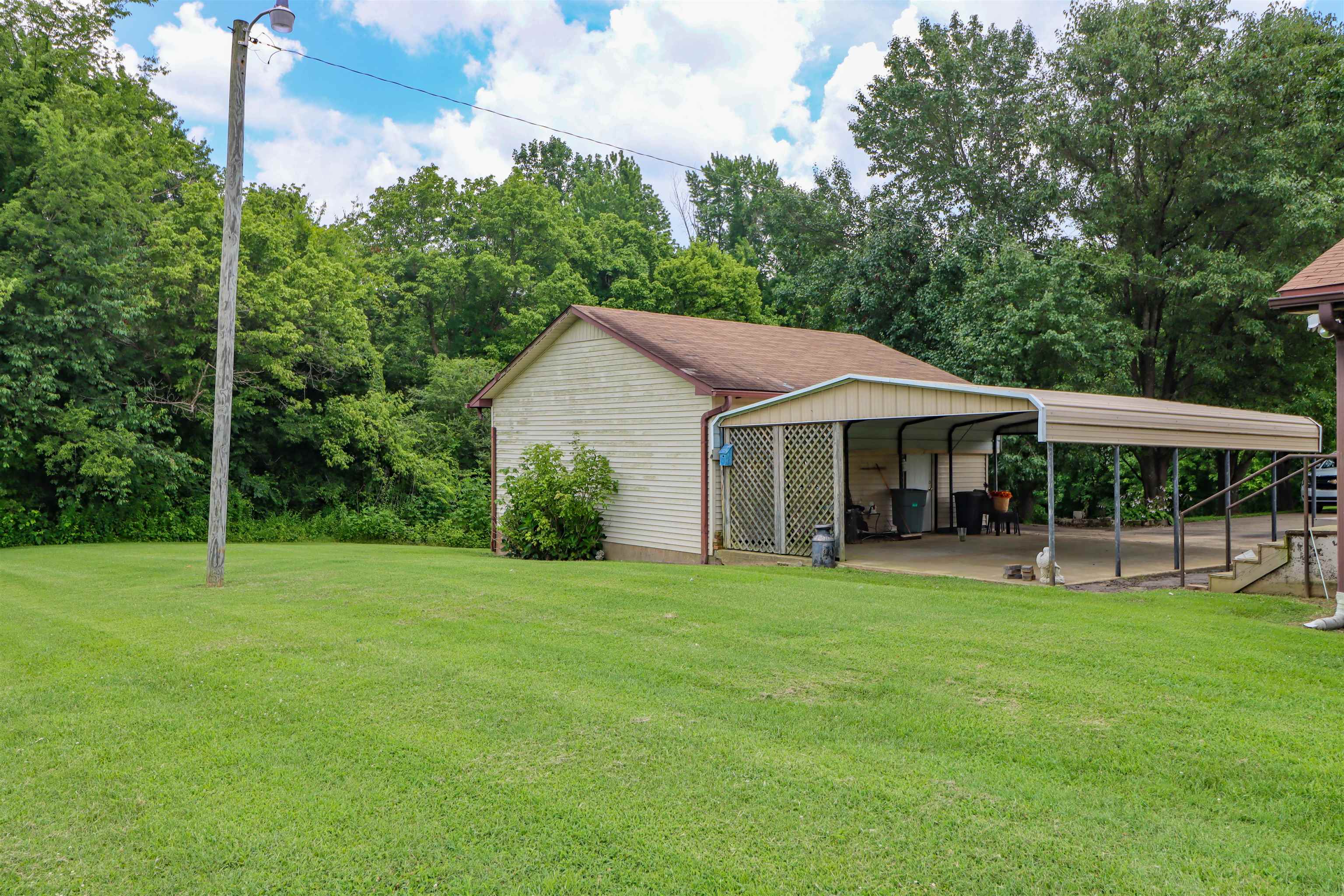 2250 Chisholm Lake Road Ripley, TN 38063 - Photo 30 of 32 a view of a house with a yard and sitting area