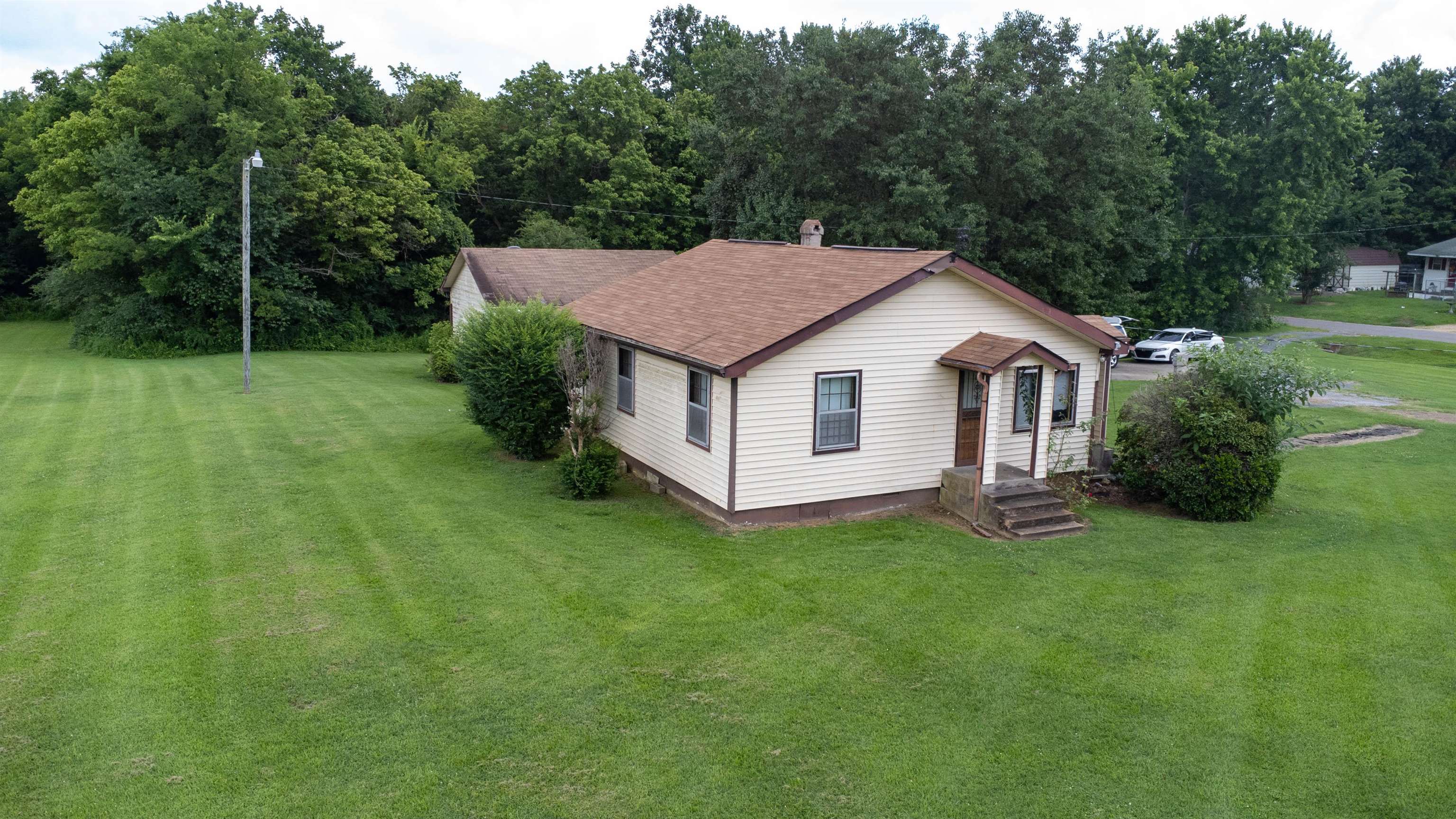 2250 Chisholm Lake Road Ripley, TN 38063 - Photo 9 of 32 a view of a house with a backyard