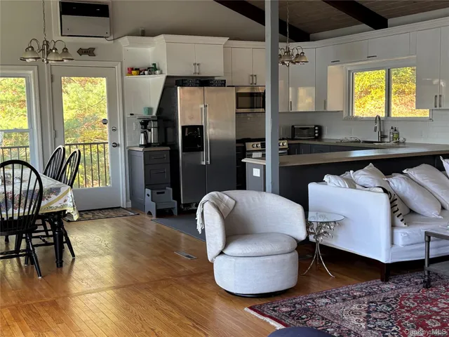 a kitchen with stainless steel appliances kitchen island granite countertop a refrigerator and a sink