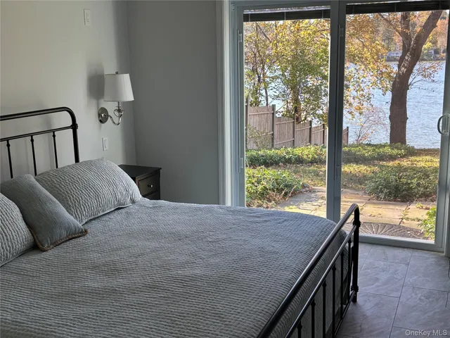 a bedroom with a bed and a view of balcony