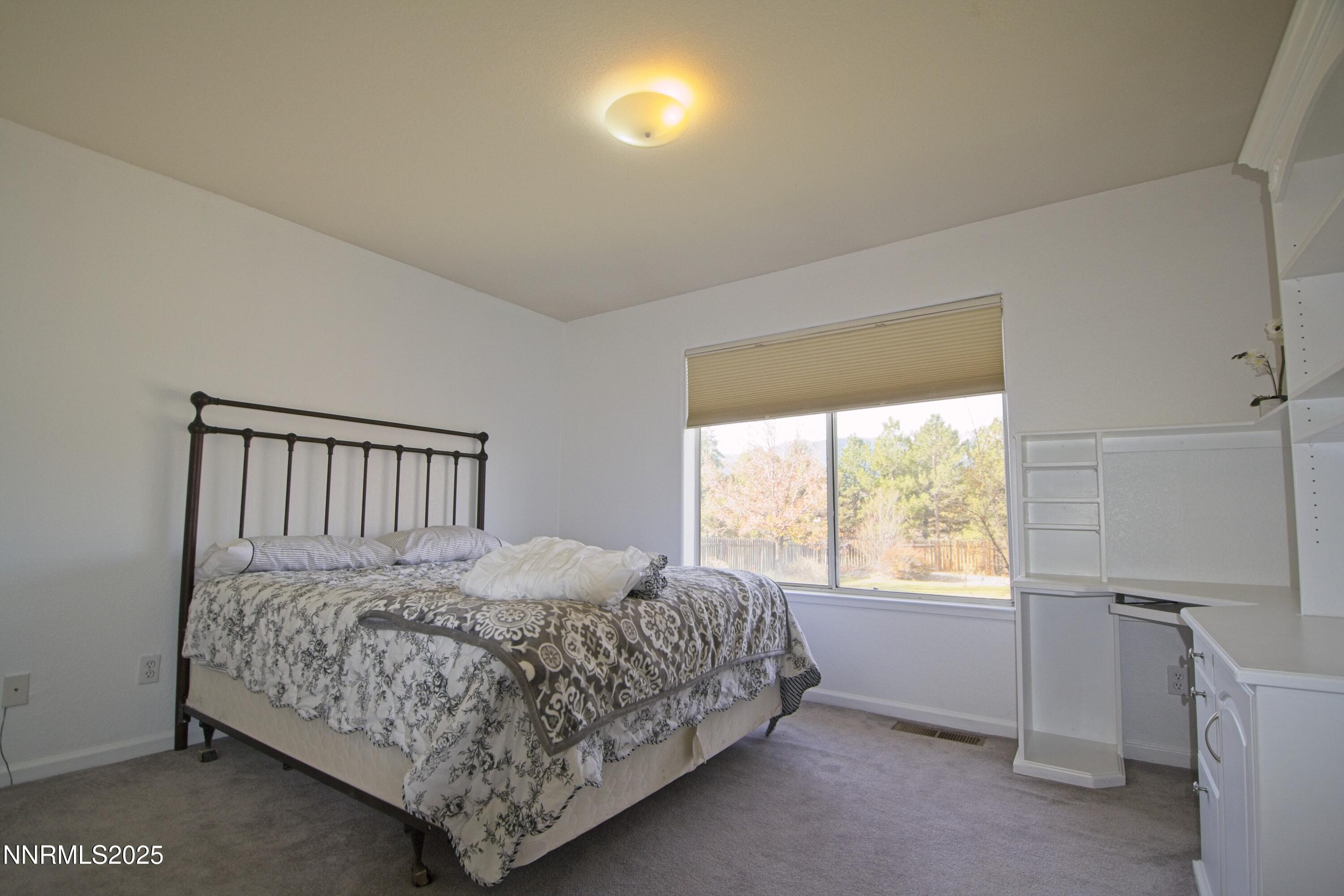 1905 Lakeshore Drive Washoe Valley, NV 89704 - Photo 11 of 31 a bedroom with a bed and window
