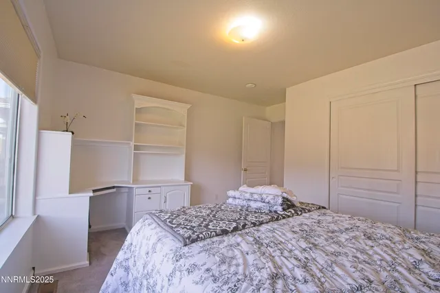 a bedroom with a bed and a cabinets