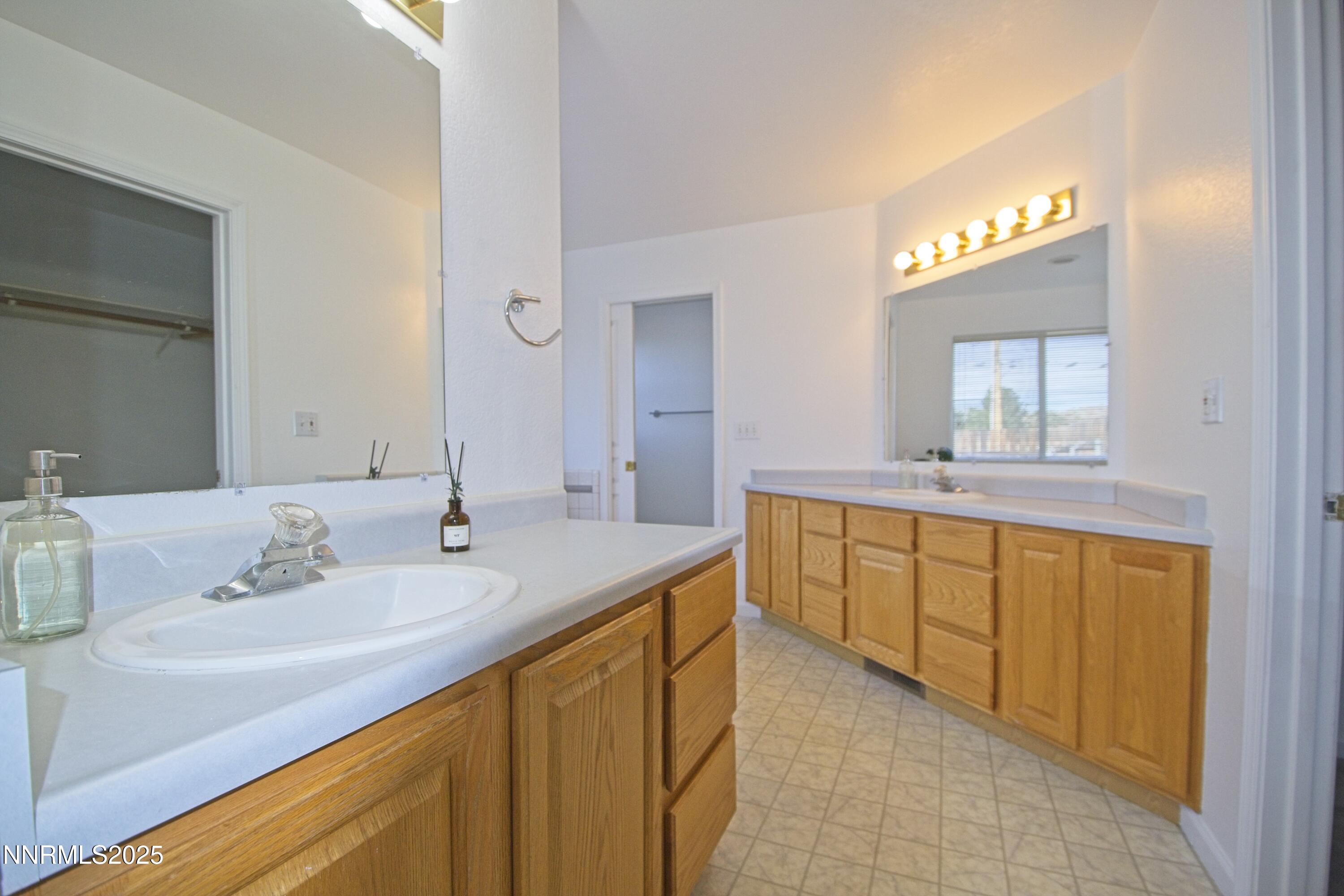 1905 Lakeshore Drive Washoe Valley, NV 89704 - Photo 16 of 31 a bathroom with a sink vanity and mirror