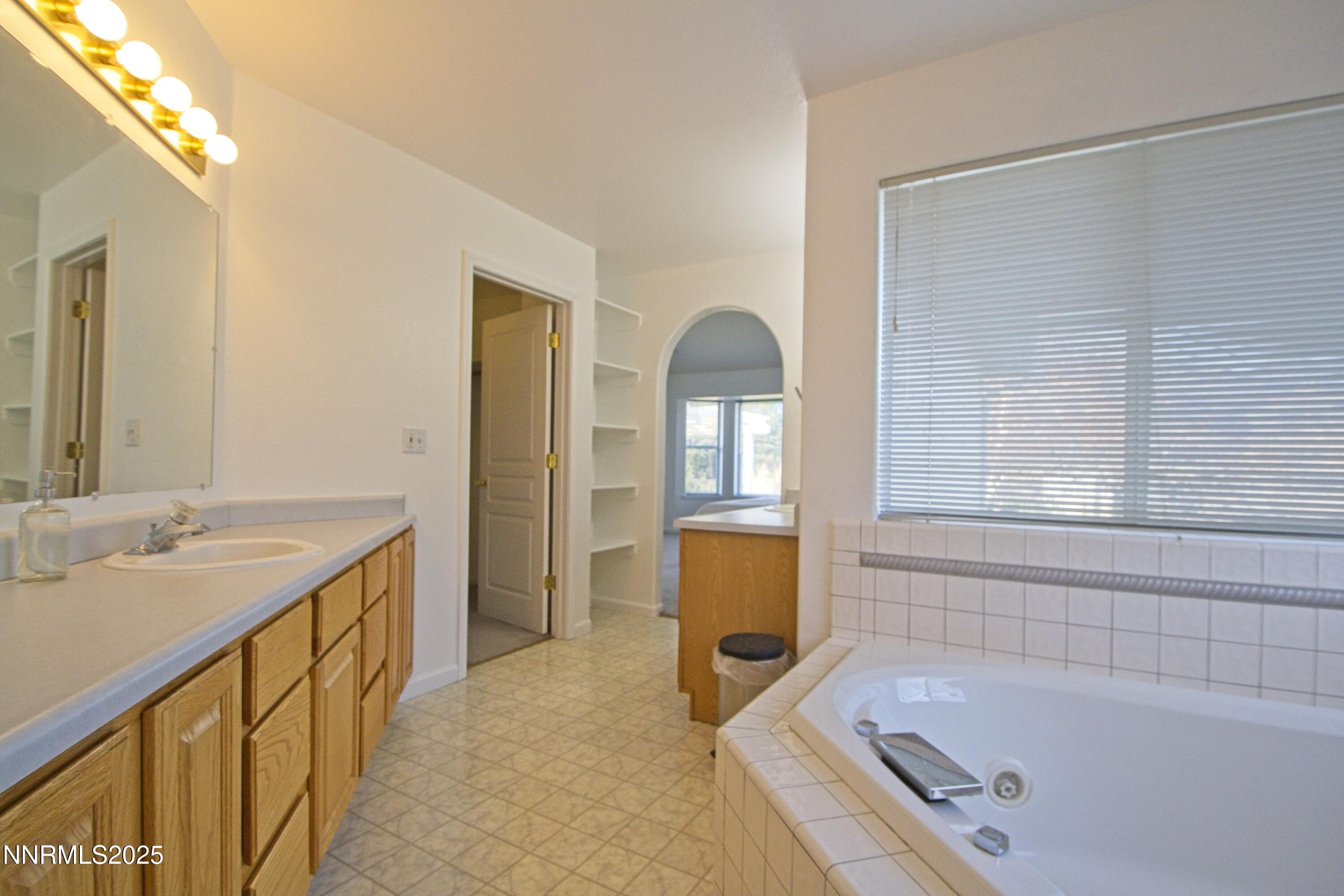 1905 Lakeshore Drive Washoe Valley, NV 89704 - Photo 17 of 31 a bathroom with a tub sink and mirror