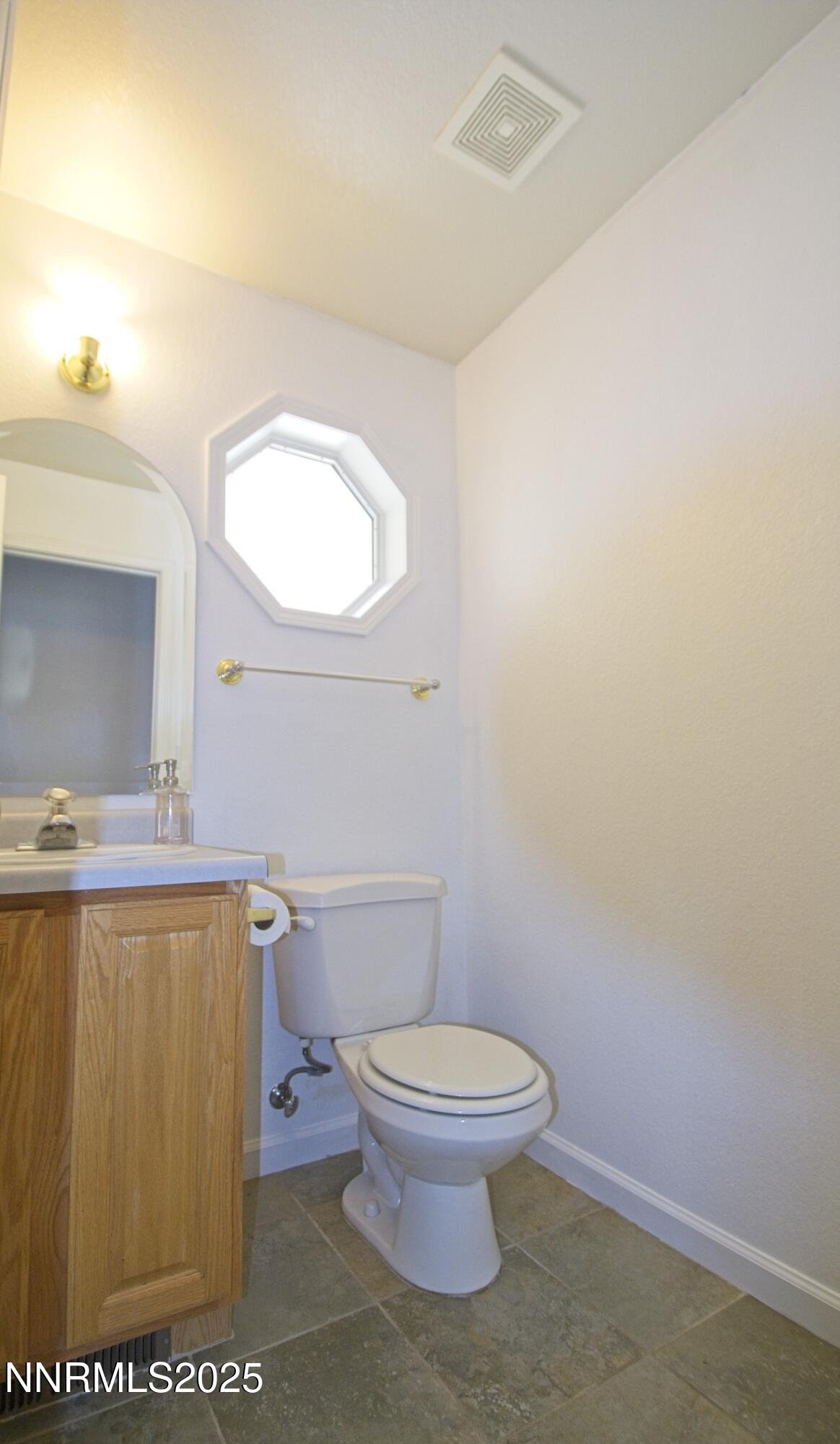 1905 Lakeshore Drive Washoe Valley, NV 89704 - Photo 19 of 31 a white toilet sitting next to a bathroom sink