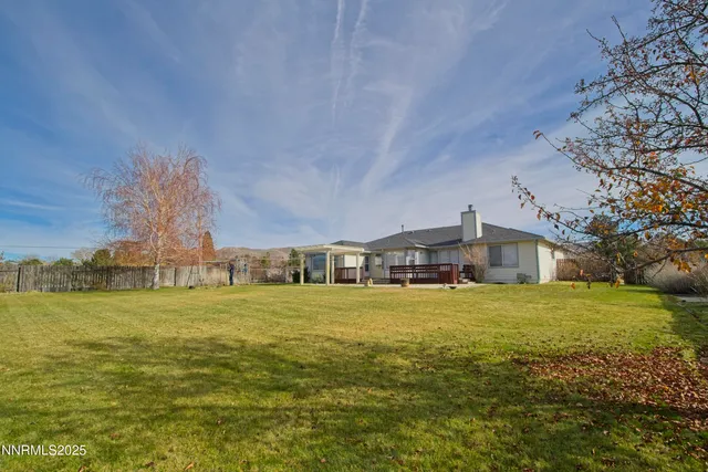 a front view of a house with a yard and lake view