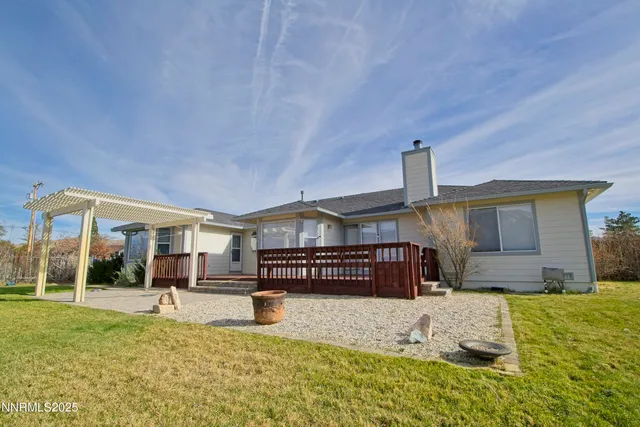 a view of a house with a yard patio and fire pit