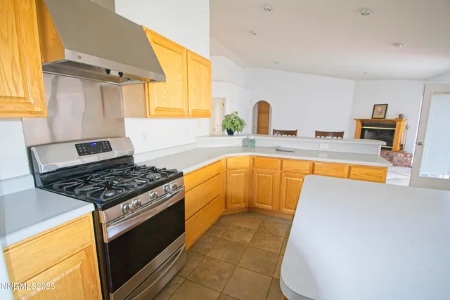 a kitchen with granite countertop a stove and a sink