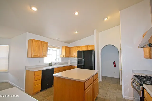 a kitchen with stainless steel appliances a sink stove and refrigerator