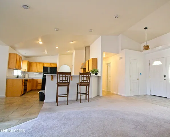 a view of a livingroom with furniture and a kitchen