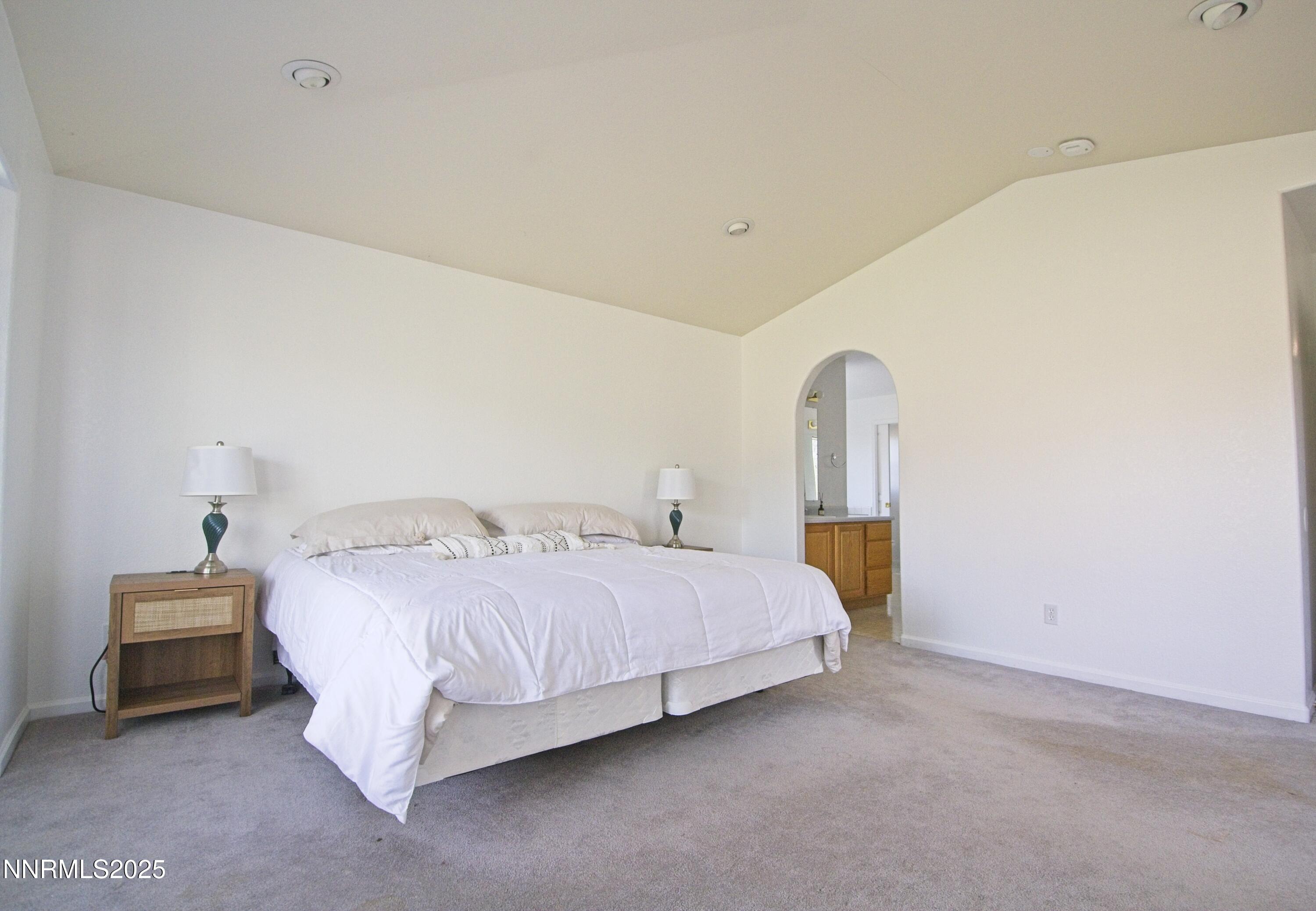 1905 Lakeshore Drive Washoe Valley, NV 89704 - Photo 10 of 31 a bedroom with a bed lamp and wooden floor