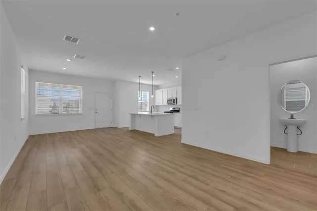 a view of a kitchen with a sink and a refrigerator