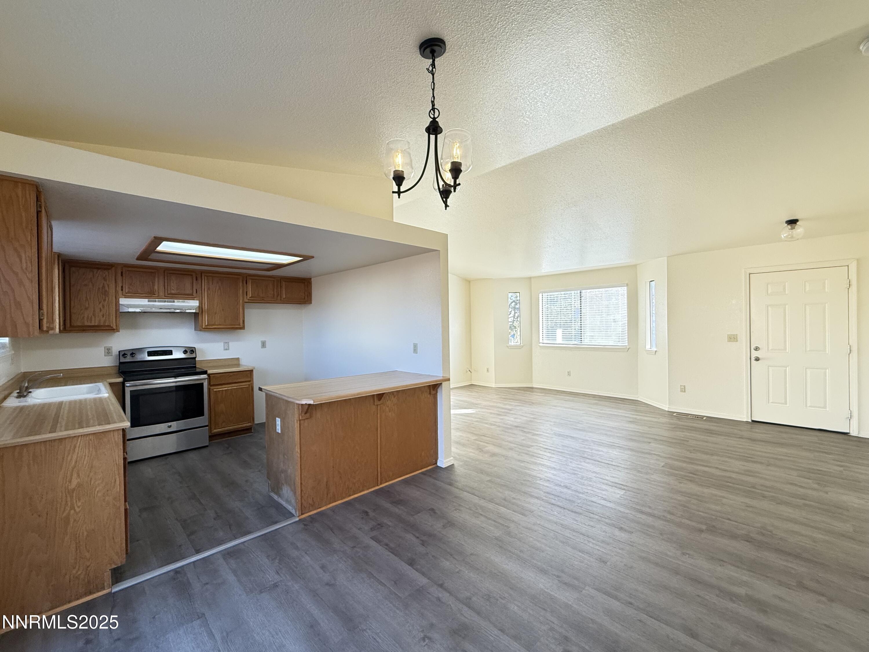 982 Ridgeview Drive Carson City, NV 89705 - Photo 5 of 16 a kitchen with stainless steel appliances granite countertop a sink cabinets and wooden floor