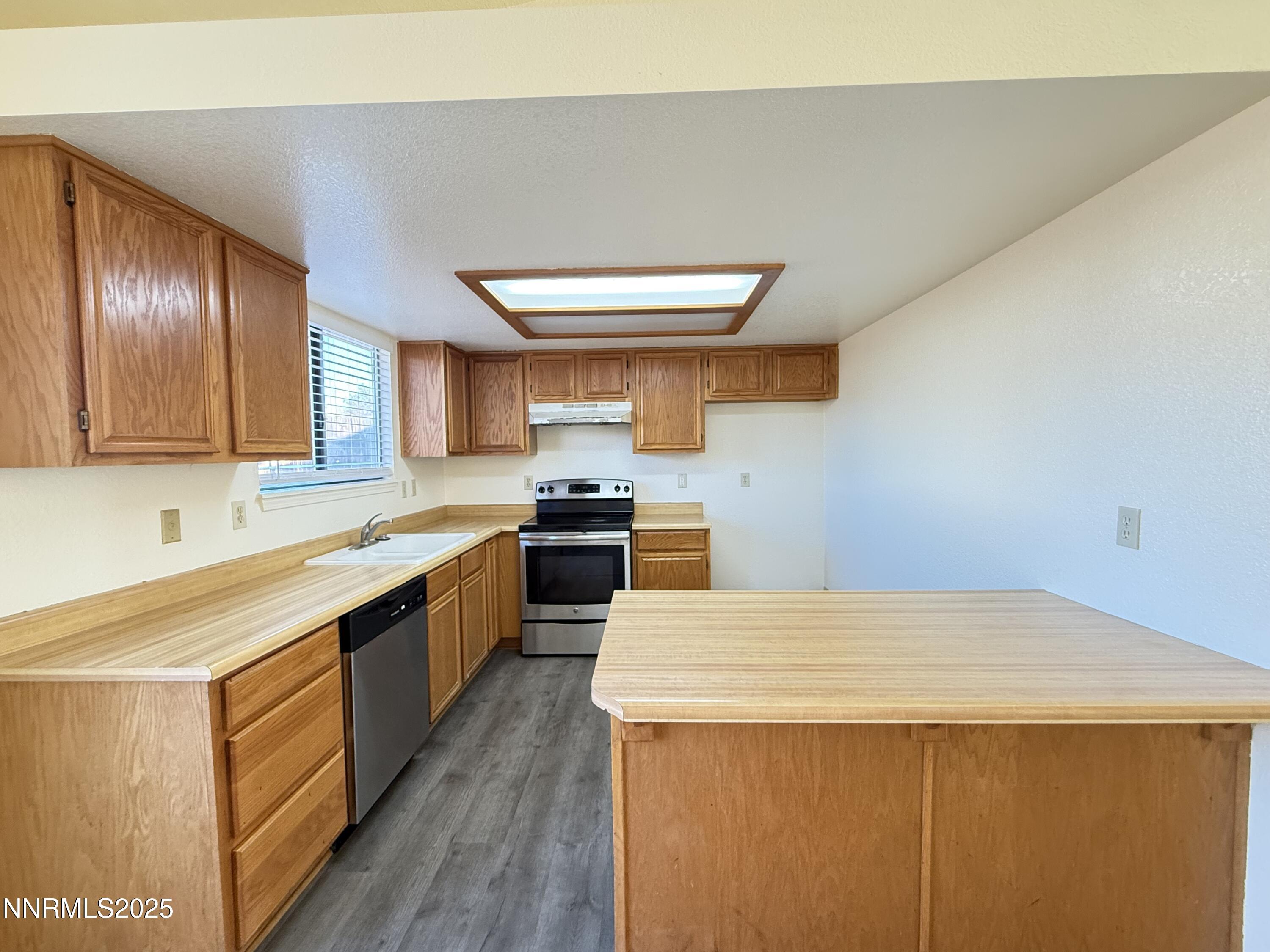 982 Ridgeview Drive Carson City, NV 89705 - Photo 6 of 16 a kitchen with stainless steel appliances a sink a stove top oven a counter space and cabinets