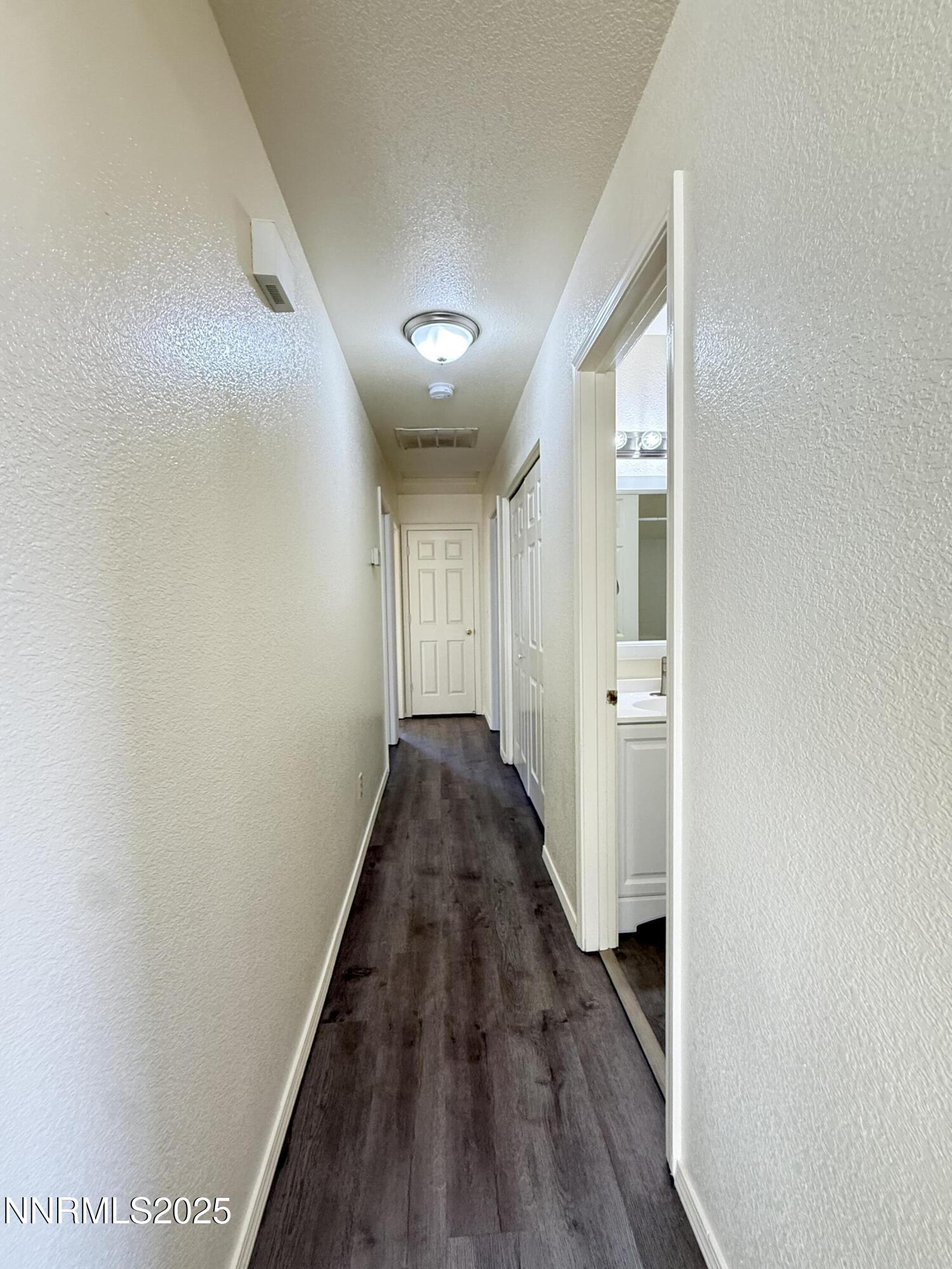982 Ridgeview Drive Carson City, NV 89705 - Photo 7 of 16 a view of a hallway with wooden floor