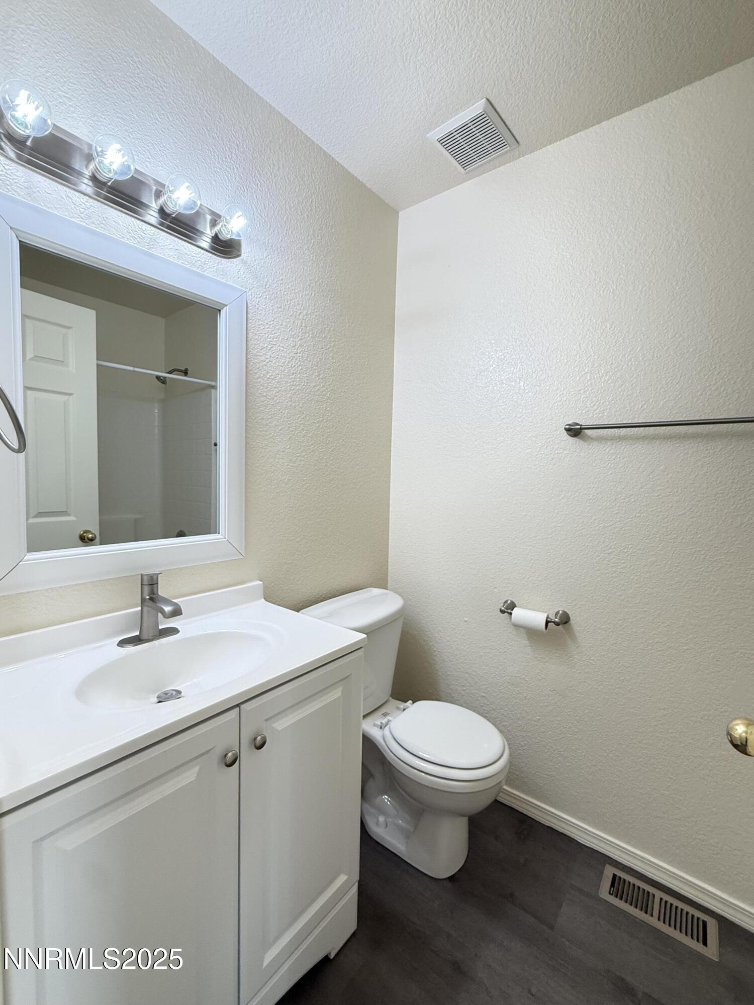 982 Ridgeview Drive Carson City, NV 89705 - Photo 8 of 16 a bathroom with a sink a toilet and mirror