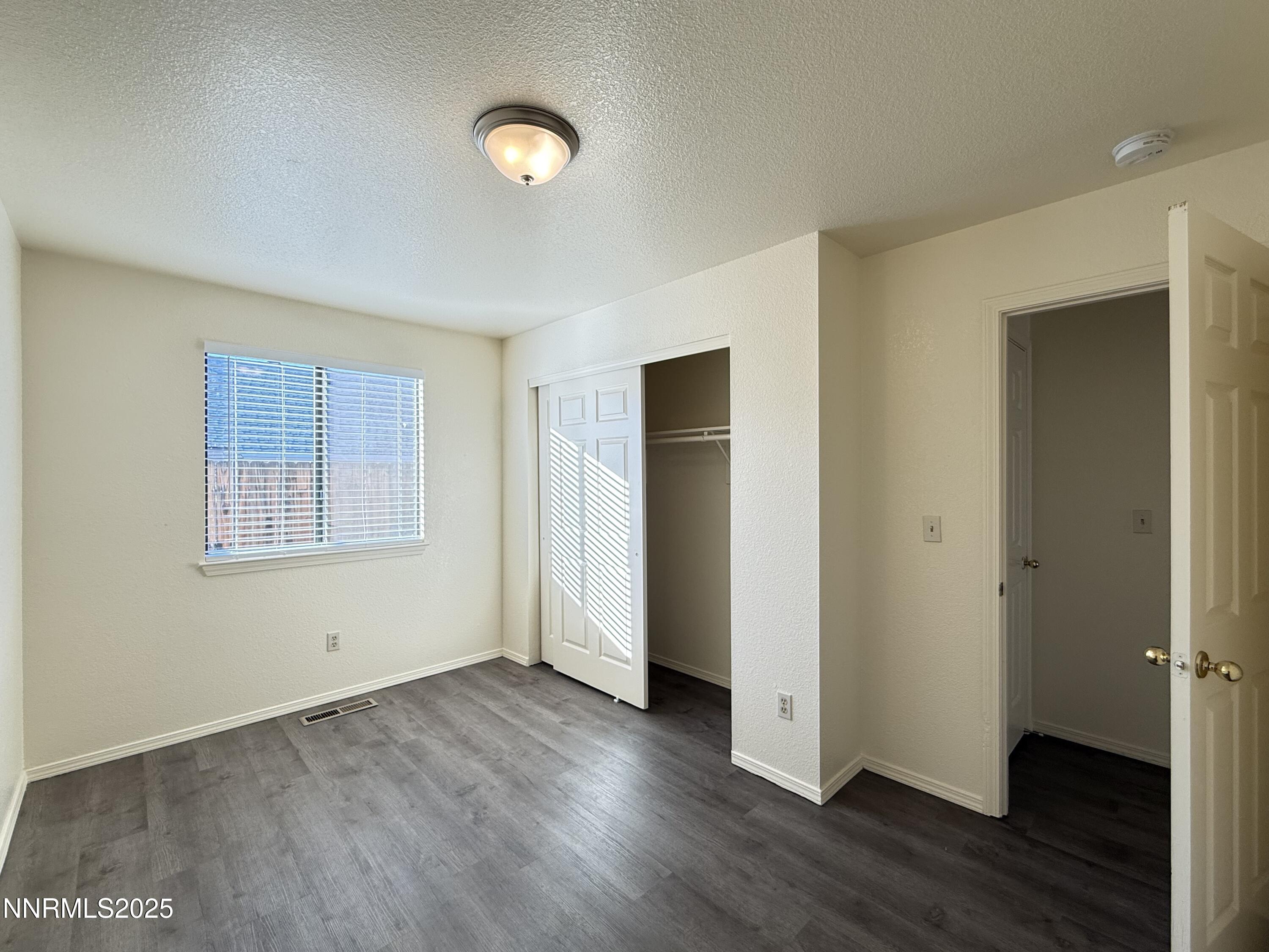 982 Ridgeview Drive Carson City, NV 89705 - Photo 10 of 16 a view of an empty room with wooden floor and a window