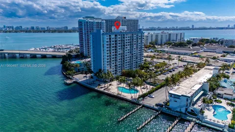 a view of a houses with a yard and a pond