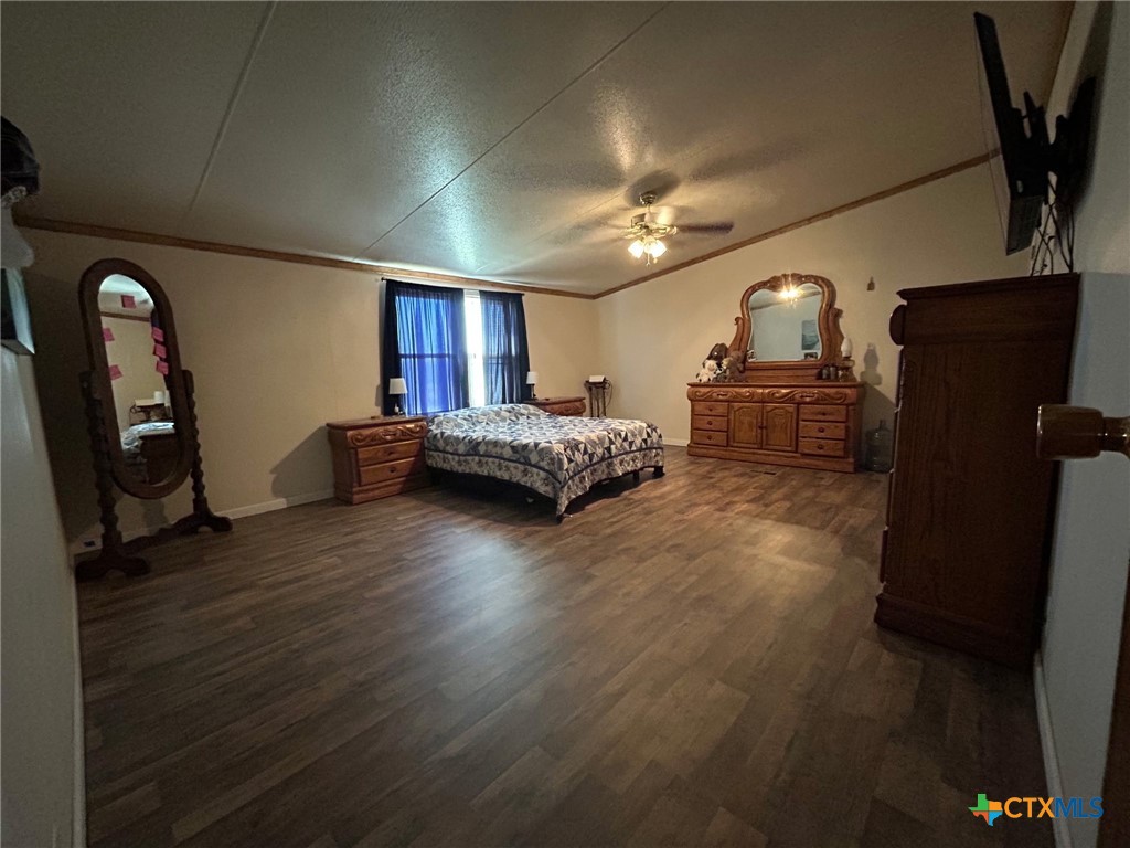 850 Blakely Road Gatesville, TX 76528 - Photo 31 of 32 a spacious bedroom with a bed and wooden floor