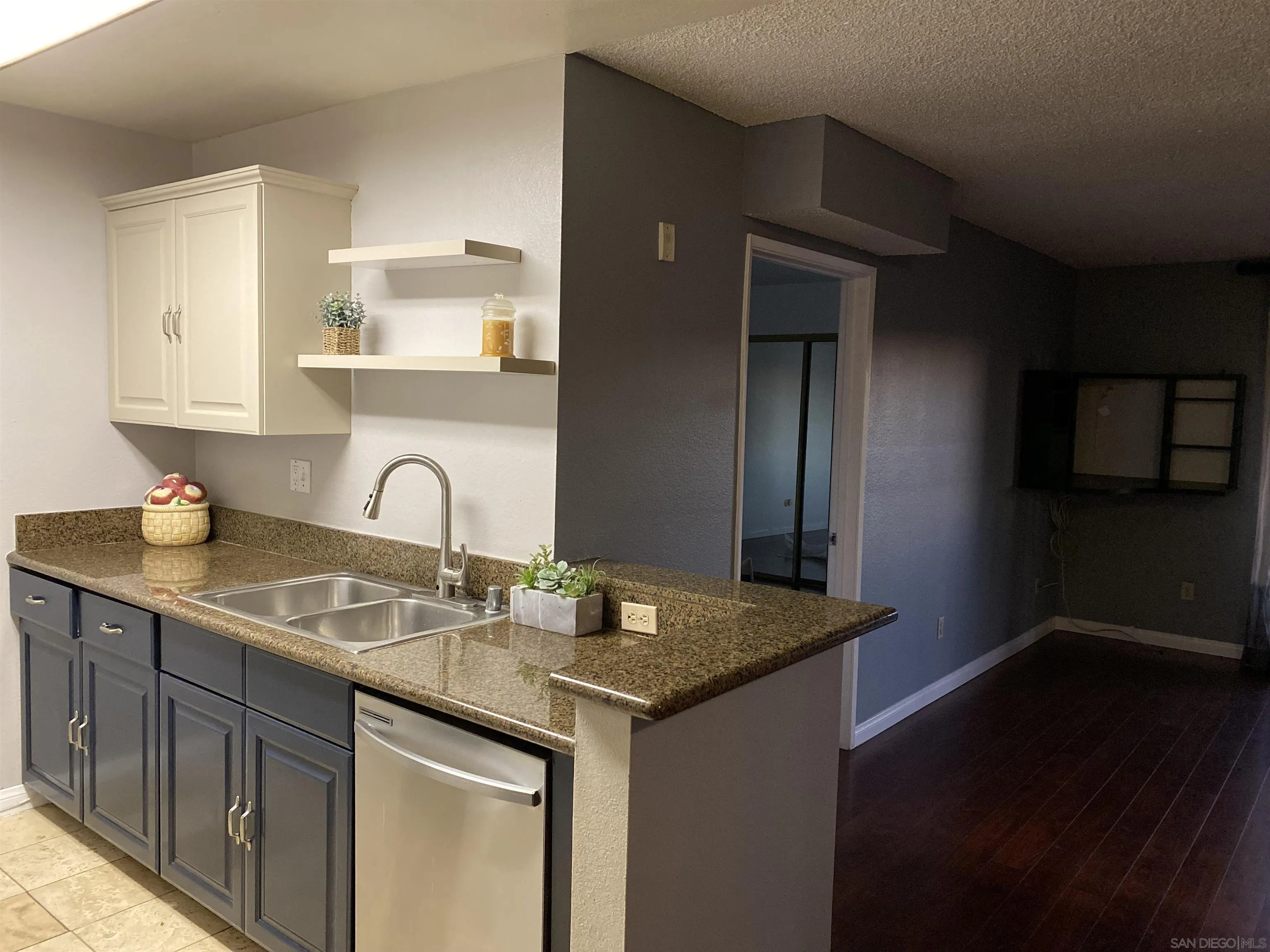 a kitchen with granite countertop a sink stainless steel appliances and cabinets