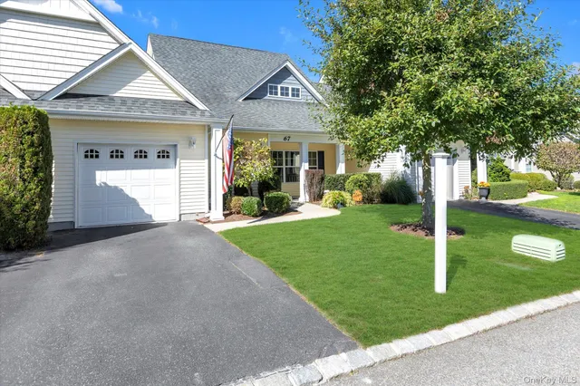 a view of a house with a yard and tree