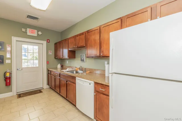 a kitchen with stainless steel appliances granite countertop a refrigerator and a stove