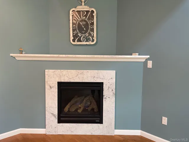 a stone fireplace with a hallway