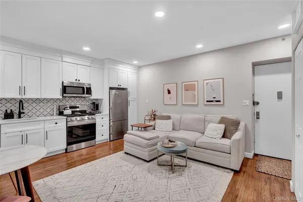 a living room with furniture and kitchen view