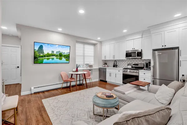 a kitchen with a refrigerator and a dining table