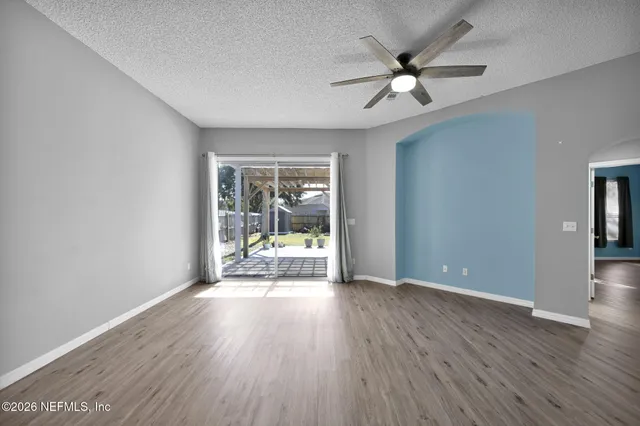 wooden floor in an empty room with a window
