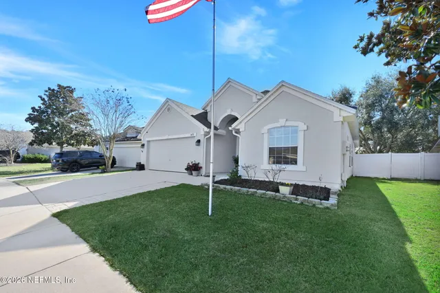 a front view of a house with a garden