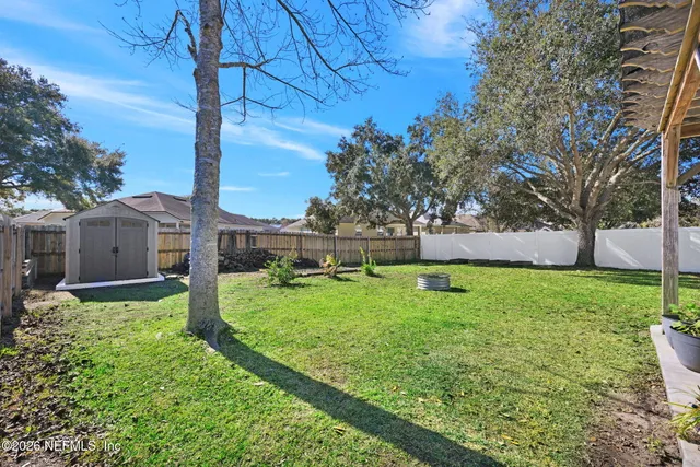 a view of backyard with small garden and deck