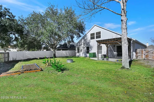 a view of backyard with a garden and plants