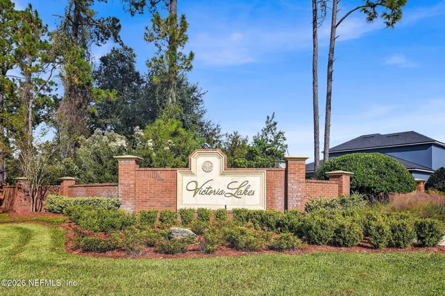 a view of a park with iron fence