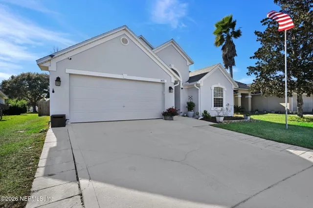 a front view of a house with a yard and garage