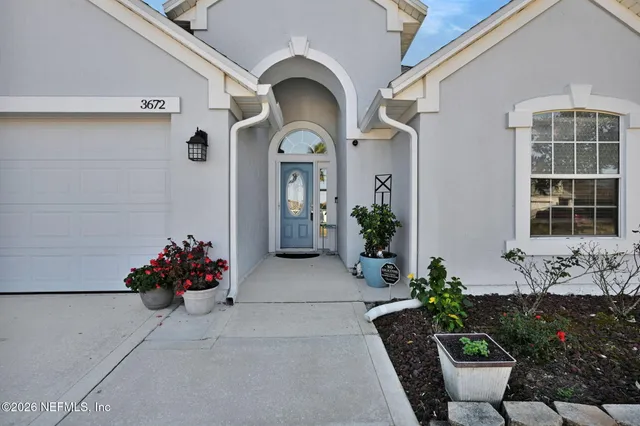 a front view of a house with flowers