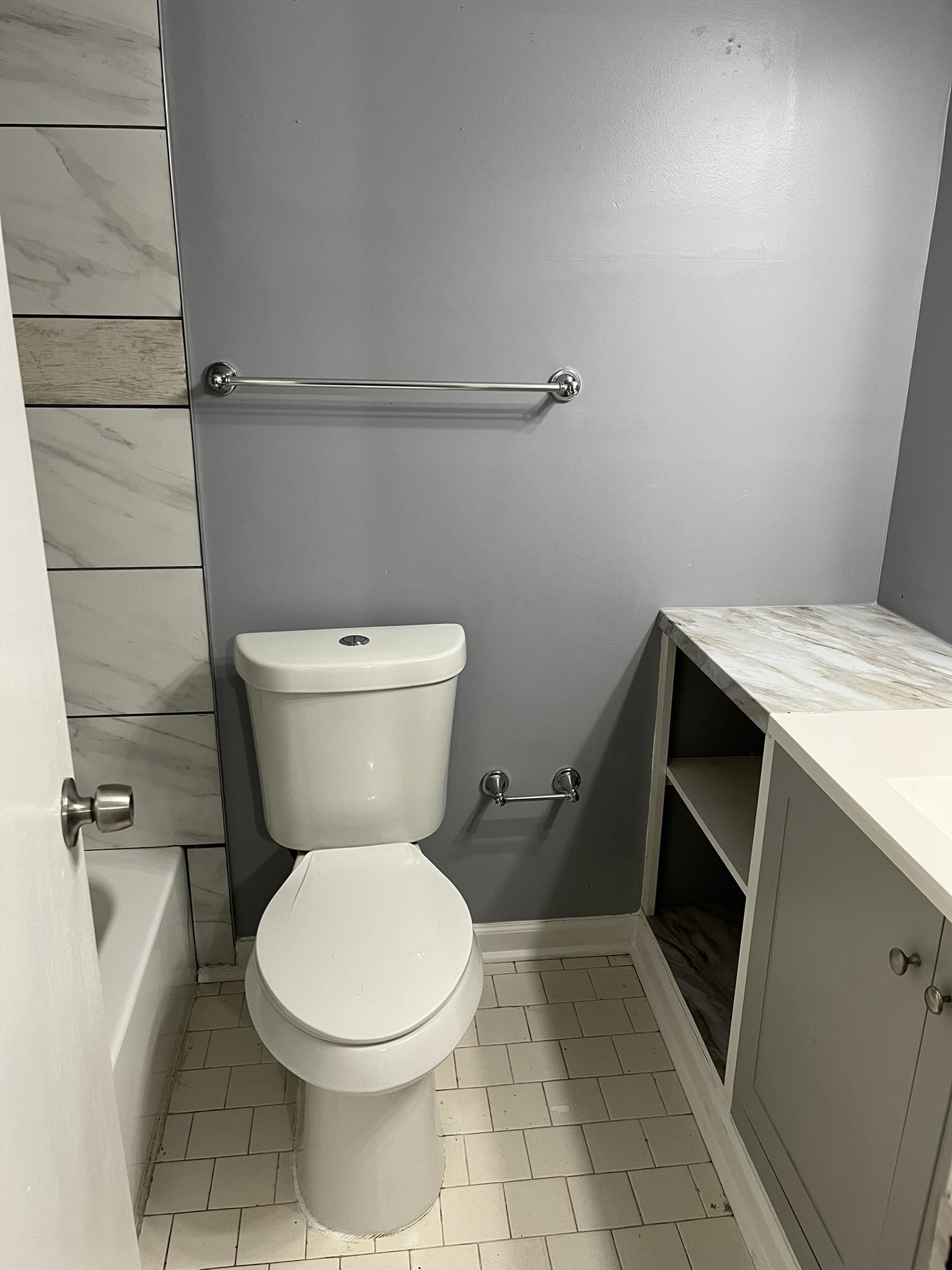 3273 Ridgemont Avenue Memphis, TN 38128 - Photo 13 of 16 a white toilet sitting next to a bathroom sink