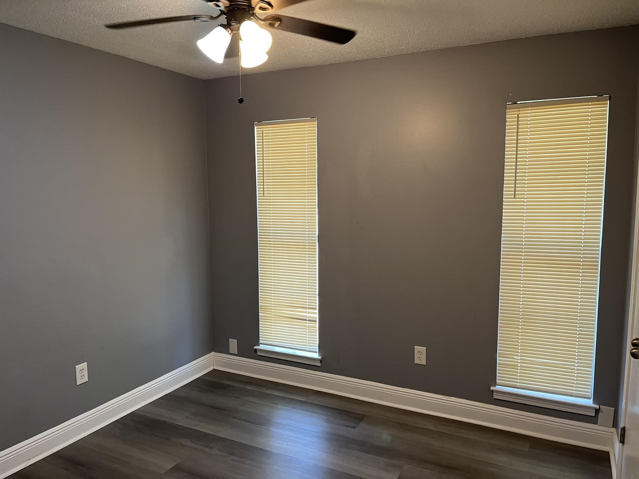 3273 Ridgemont Avenue Memphis, TN 38128 - Photo 15 of 16 an empty room with wooden floor and windows