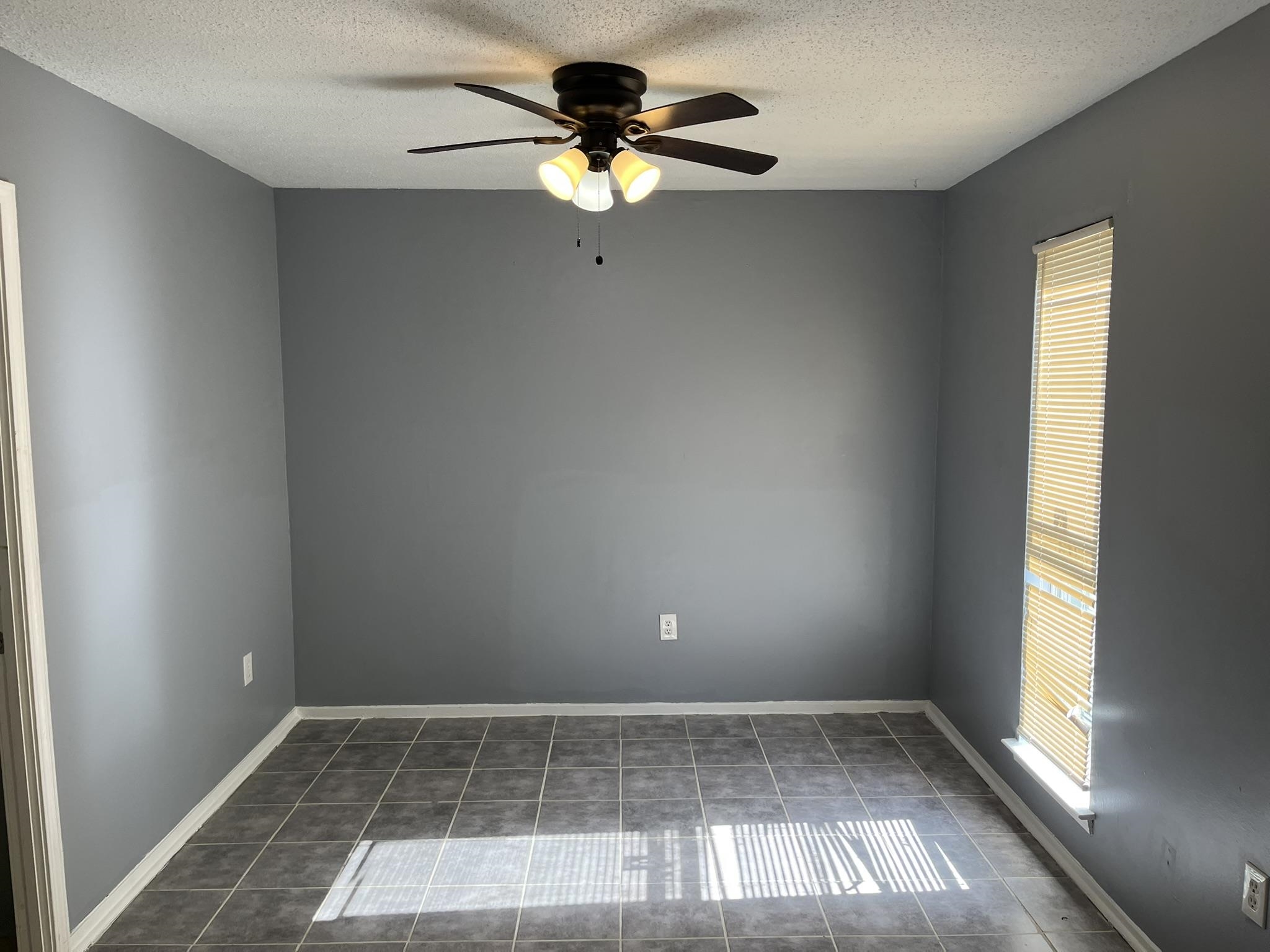 3273 Ridgemont Avenue Memphis, TN 38128 - Photo 6 of 16 wooden floor in an empty room with a window