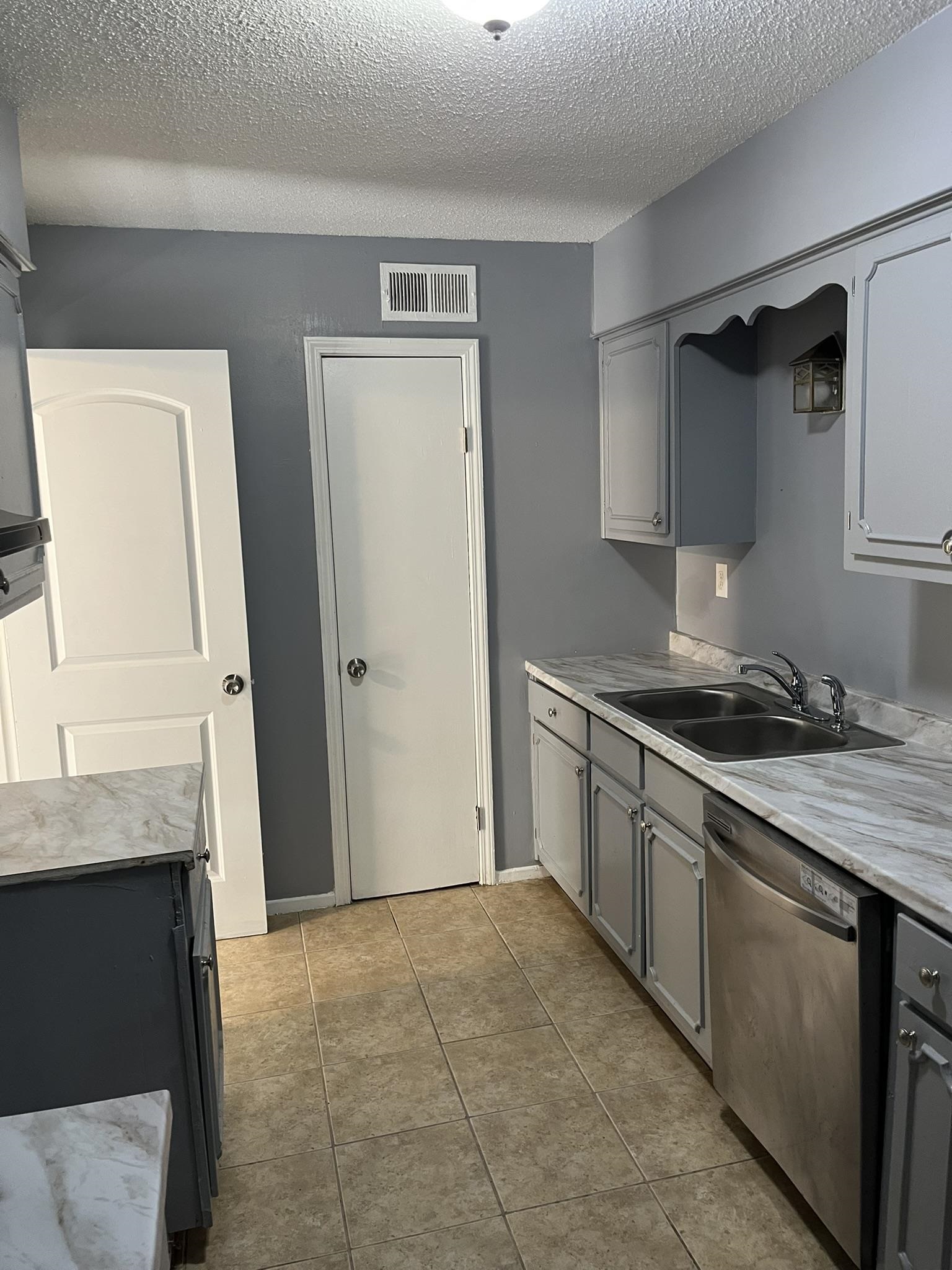 3273 Ridgemont Avenue Memphis, TN 38128 - Photo 8 of 16 a kitchen with stainless steel appliances granite countertop a stove and a refrigerator