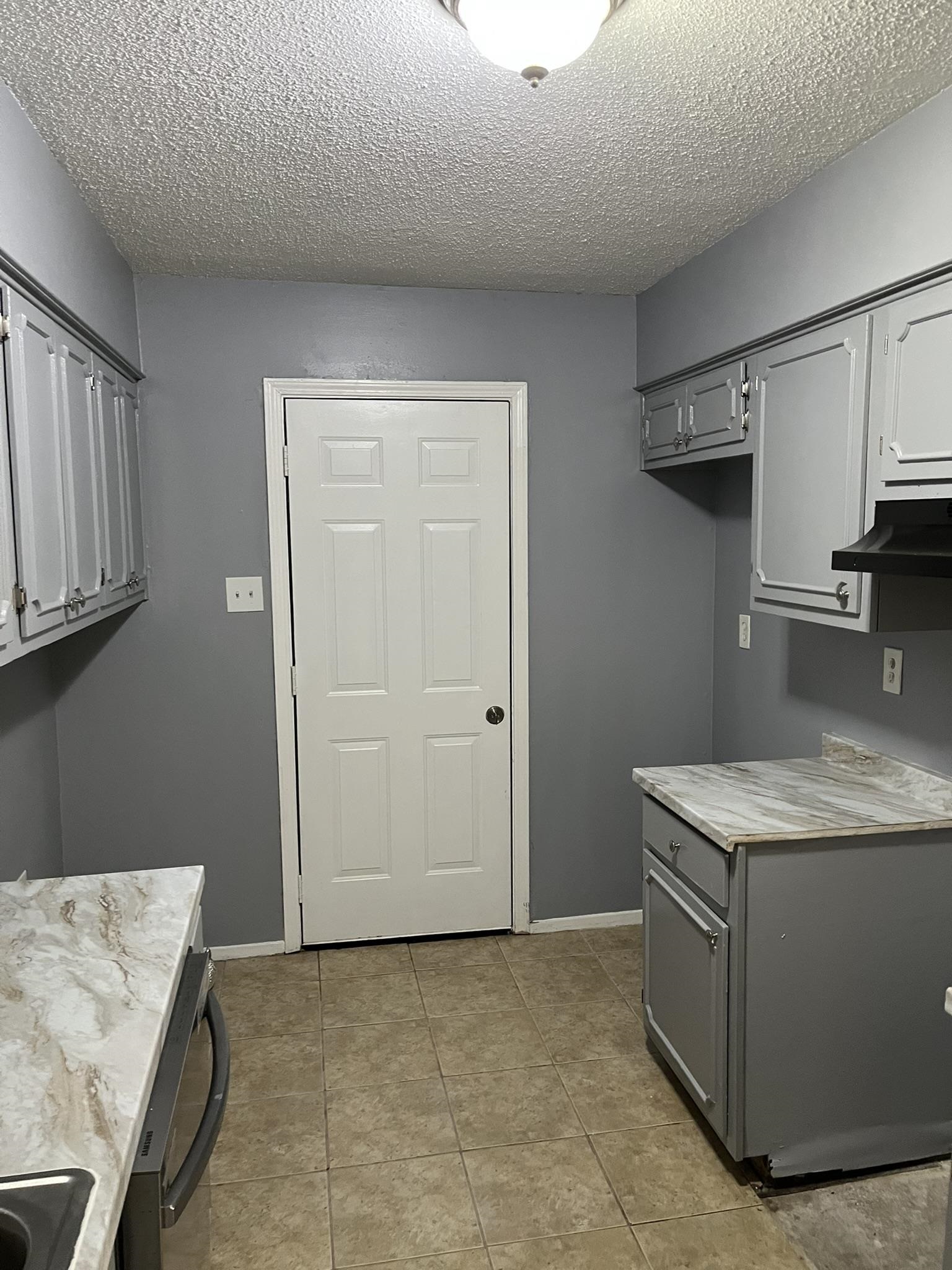 3273 Ridgemont Avenue Memphis, TN 38128 - Photo 9 of 16 a kitchen with stainless steel appliances granite countertop a sink stove and cabinets