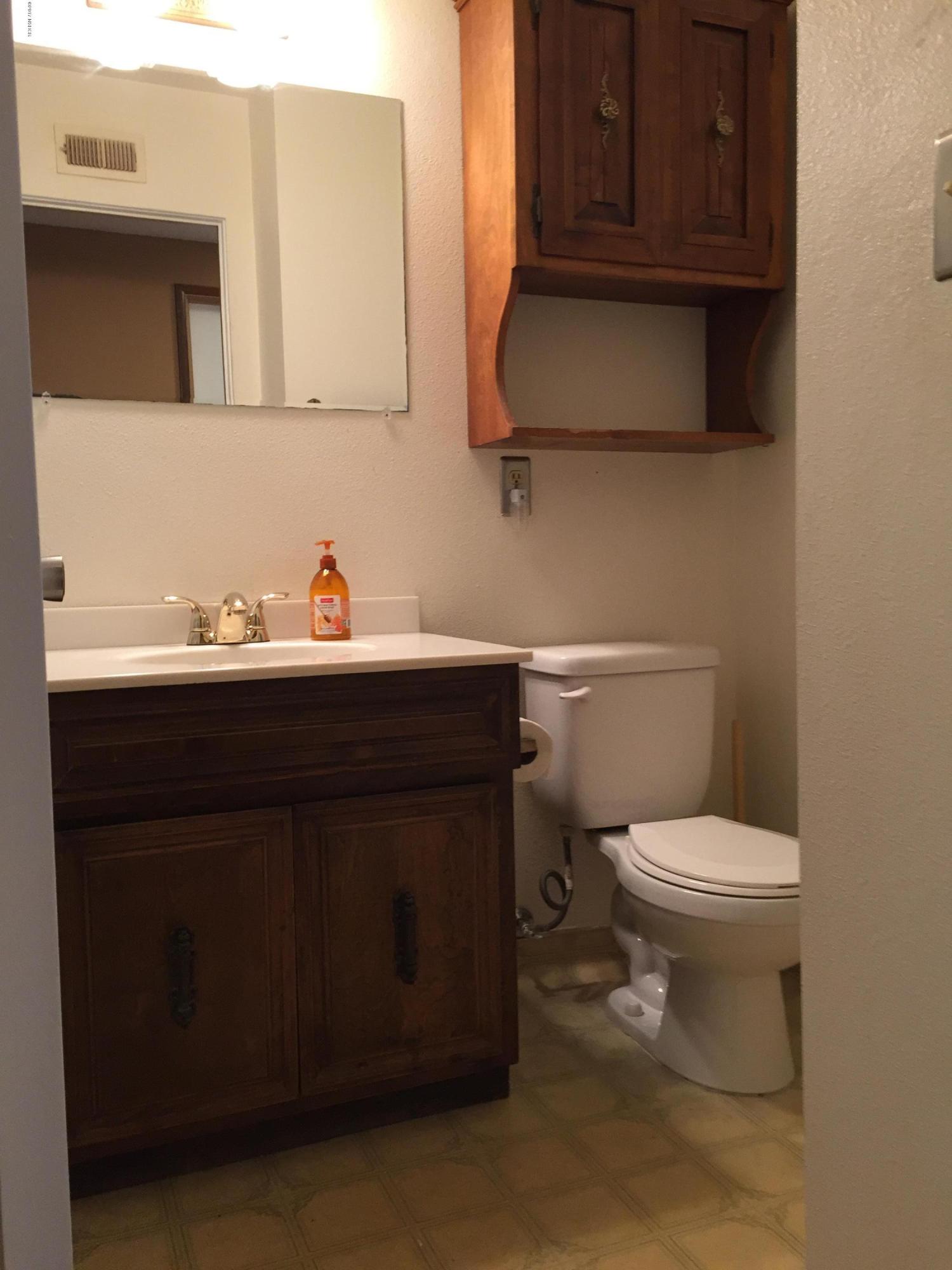 4035 Rigel Avenue Lompoc, CA 93436 - Photo 17 of 35 a bathroom with a sink toilet and mirror