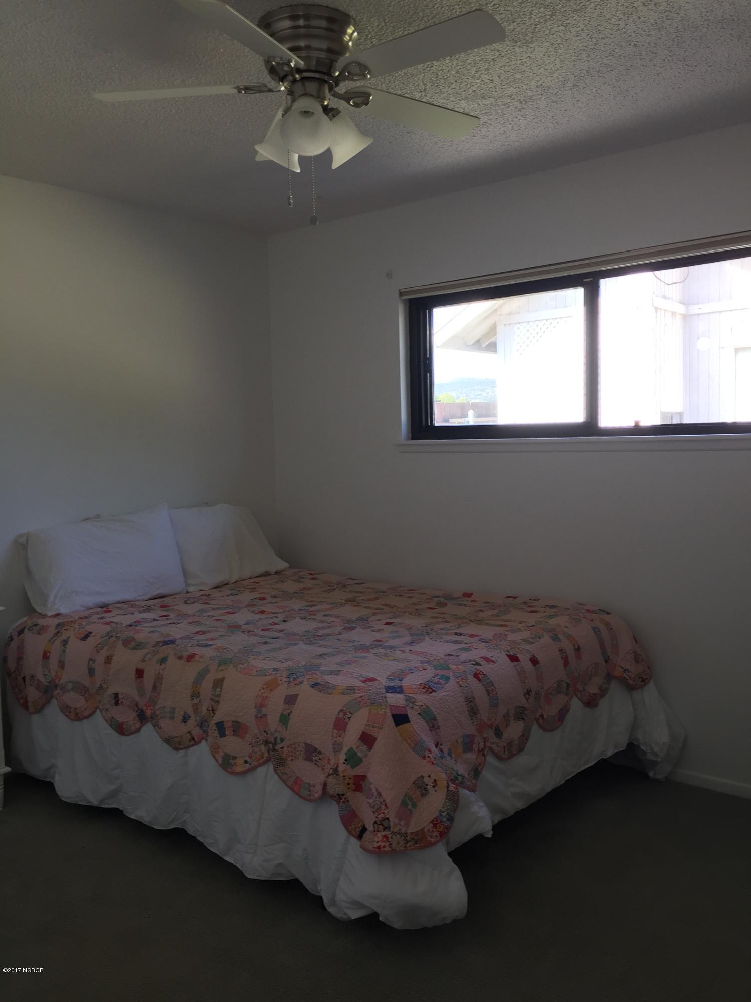 4035 Rigel Avenue Lompoc, CA 93436 - Photo 21 of 35 a bed sitting in a bedroom next to a window