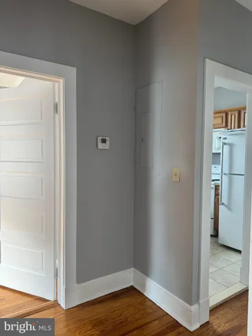 a view of a hallway with wooden floor