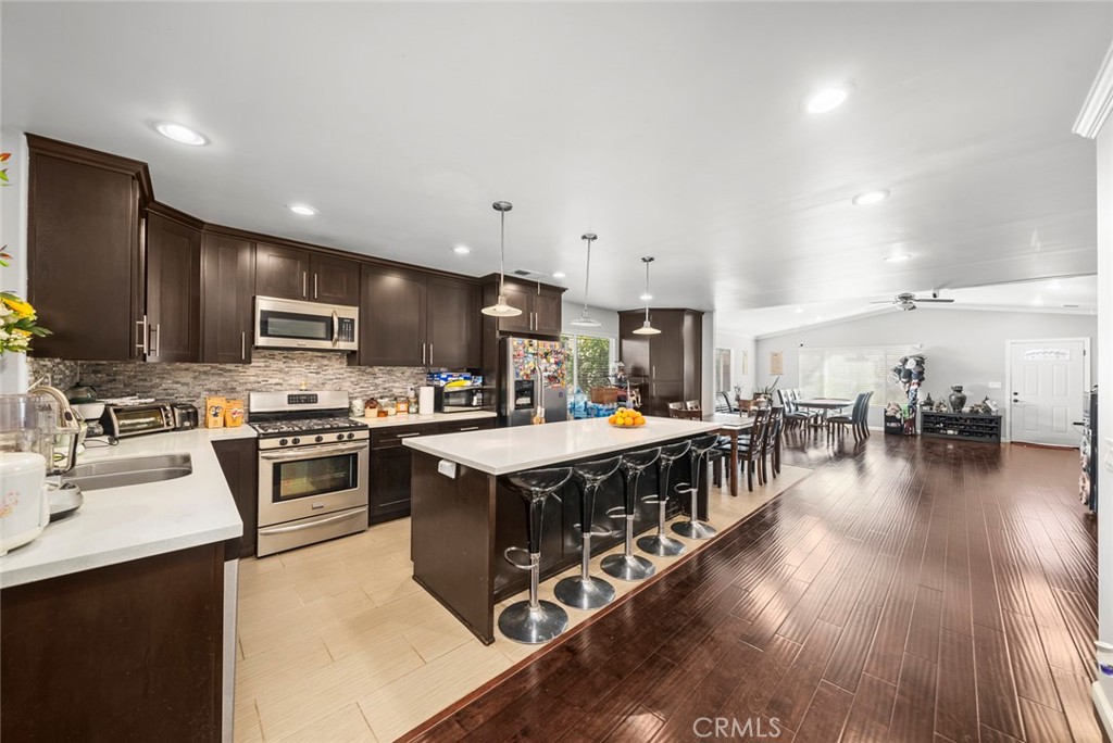 a large kitchen with stainless steel appliances granite countertop a large center island and a stove