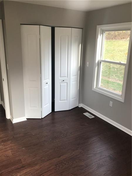 118 Sunflower Road Butler, PA 16001 - Photo 16 of 25 2nd bedroom has two large windows, large closet with shelving and light.
